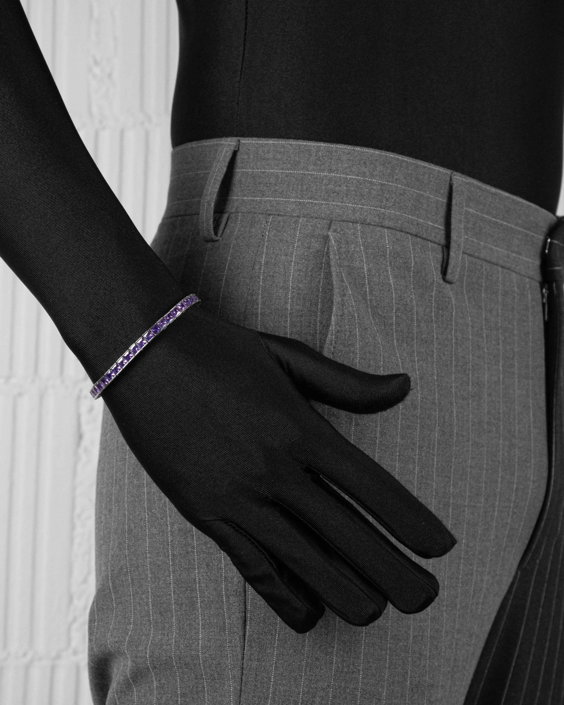 man with black suit wearing white tennis bracelet with hand-set princess-cut amethyst stones