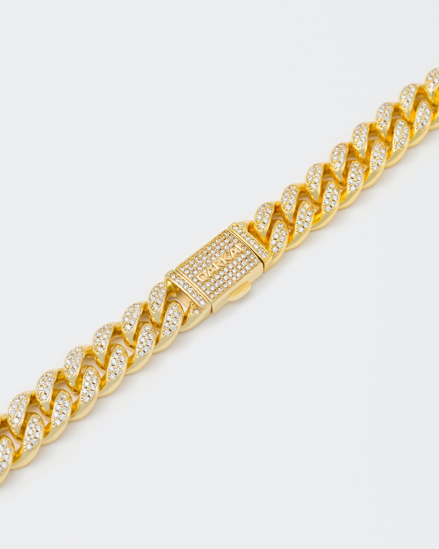 detail of 18k yellow gold coated cuban chain bracelet with hand-set micropavé stones in white