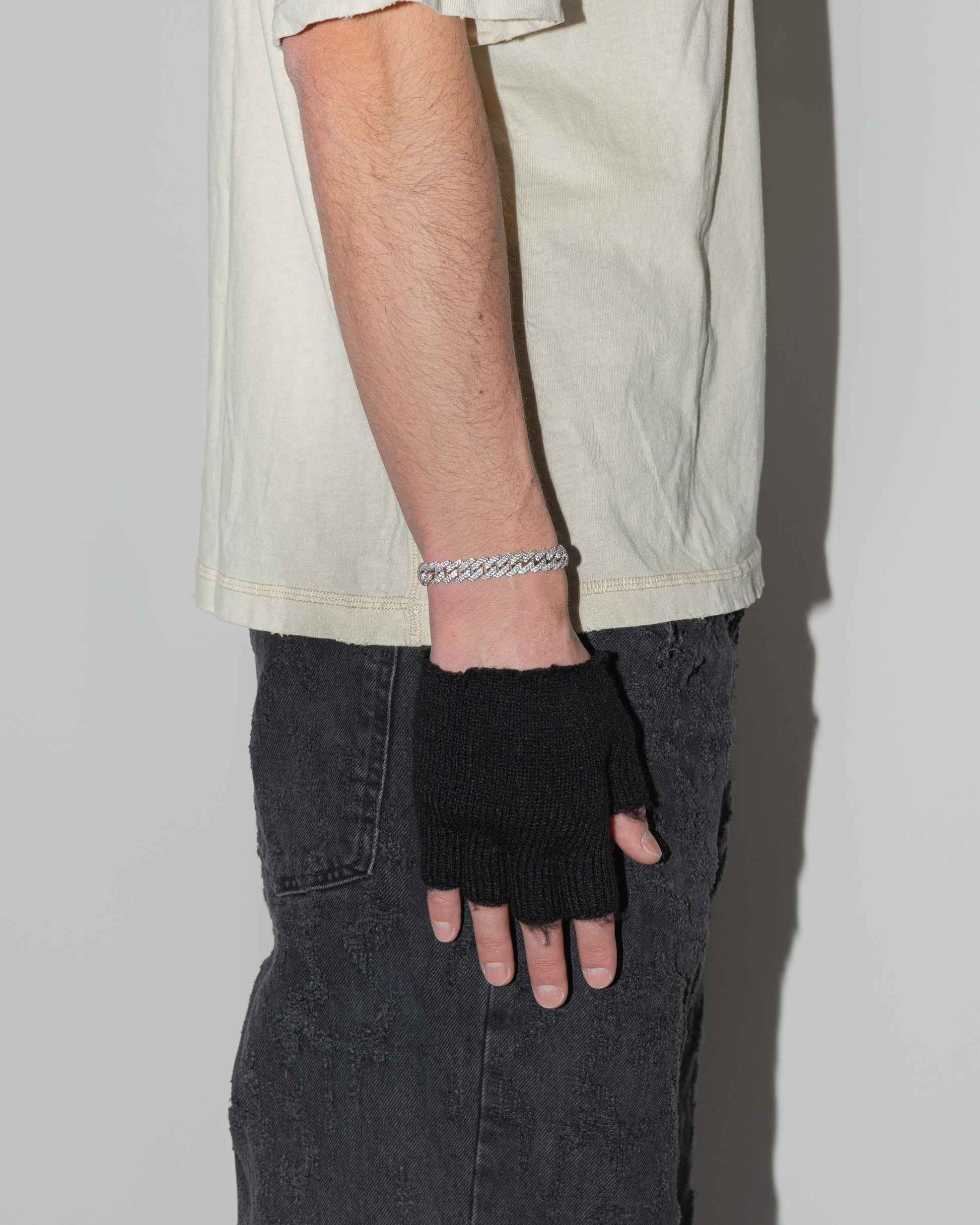 street style man wearing 8k white gold coated mini prong chain bracelet with hand-set micropavé stones in white