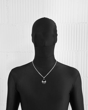 man with black suit wearing 18k white gold coated alien pendant necklace with hand-set micropavé stones in white on black alien pendant and 3mm rolo chain