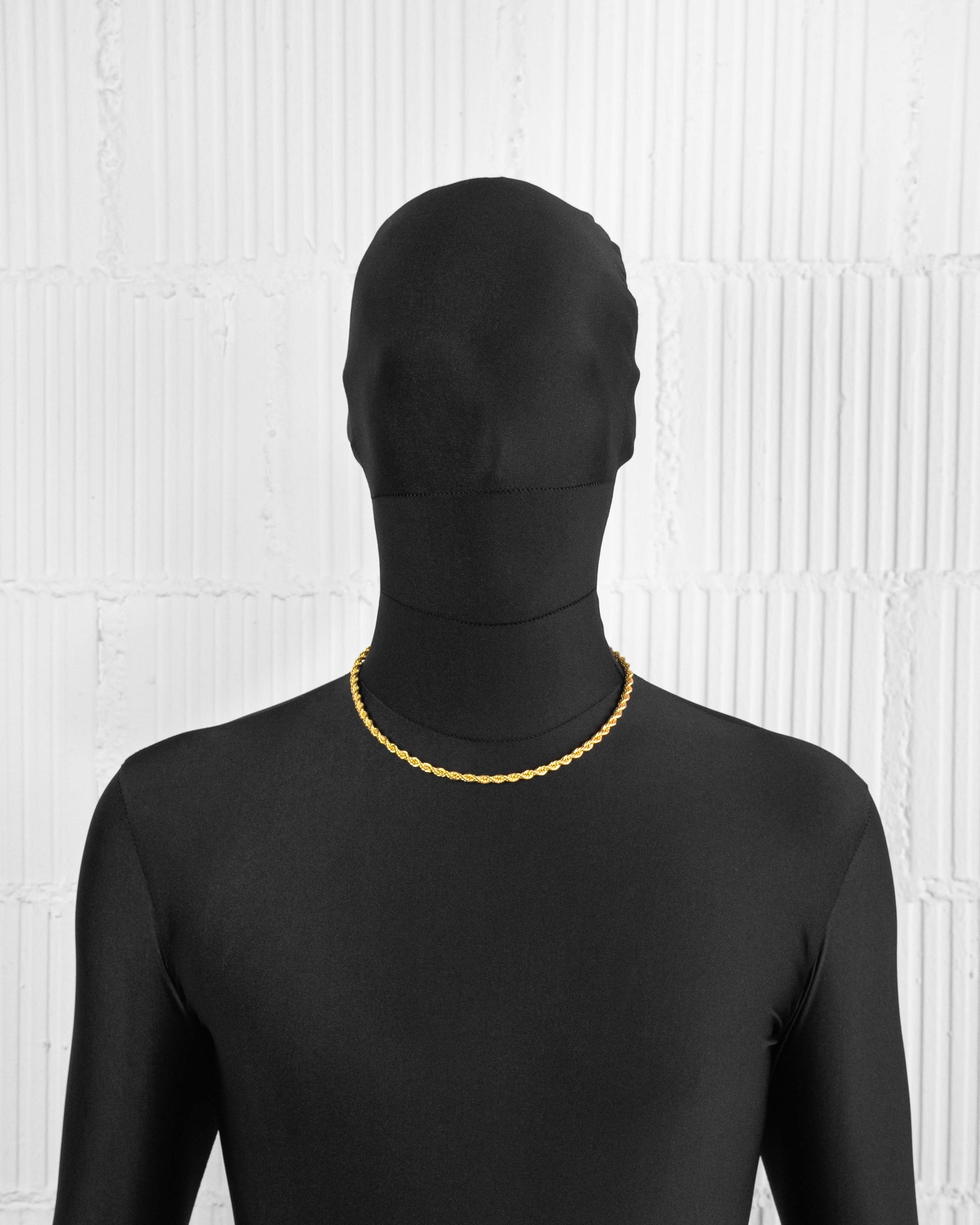 man with black suit wearing 18k yellow or white gold coated rope chain necklace with lasered logo tag and lobster clasp